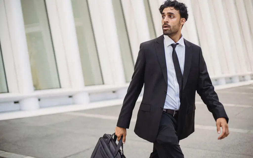 Business traveller in a suit carrying a briefcase